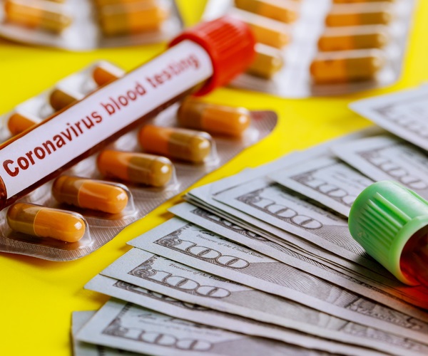 coronavirus testing blood samples in testtubes amid sealed pills and $100 bills