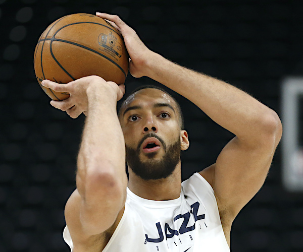 rudy gobert lines up for a free throw with the ball above his head