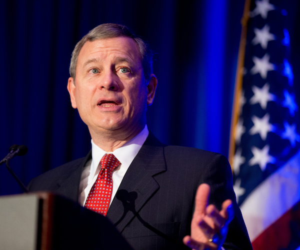 john roberts exults during a speech behind a podium