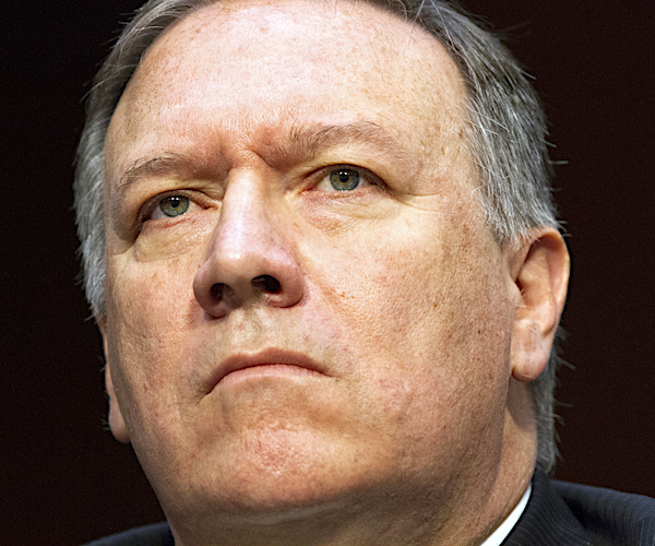 mike pompeo looks up with a stern face during a congressional hearing
