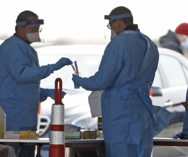 healthcare workers at a drive-through covid-19 virus testing site in wantagh, new york