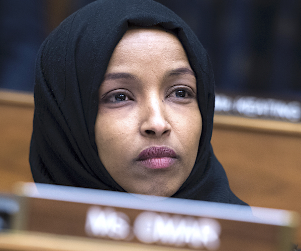ilhan omar sits and listens during a house committee hearing