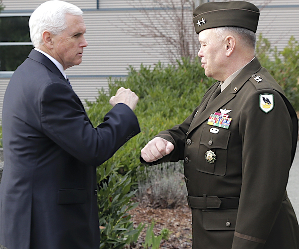 Vice President Mike Pence bumps elbows with Maj. Gen. Bret Daugherty