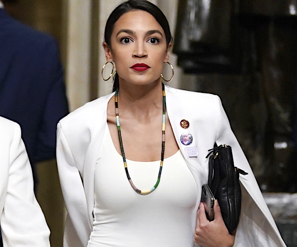 Alexandria Ocasio-Cortez walks briskly through capitol hill to get to president donald trump's state of the union