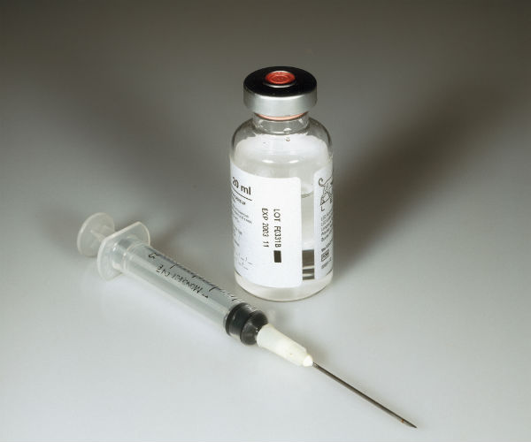 a drug vial and needle are shown